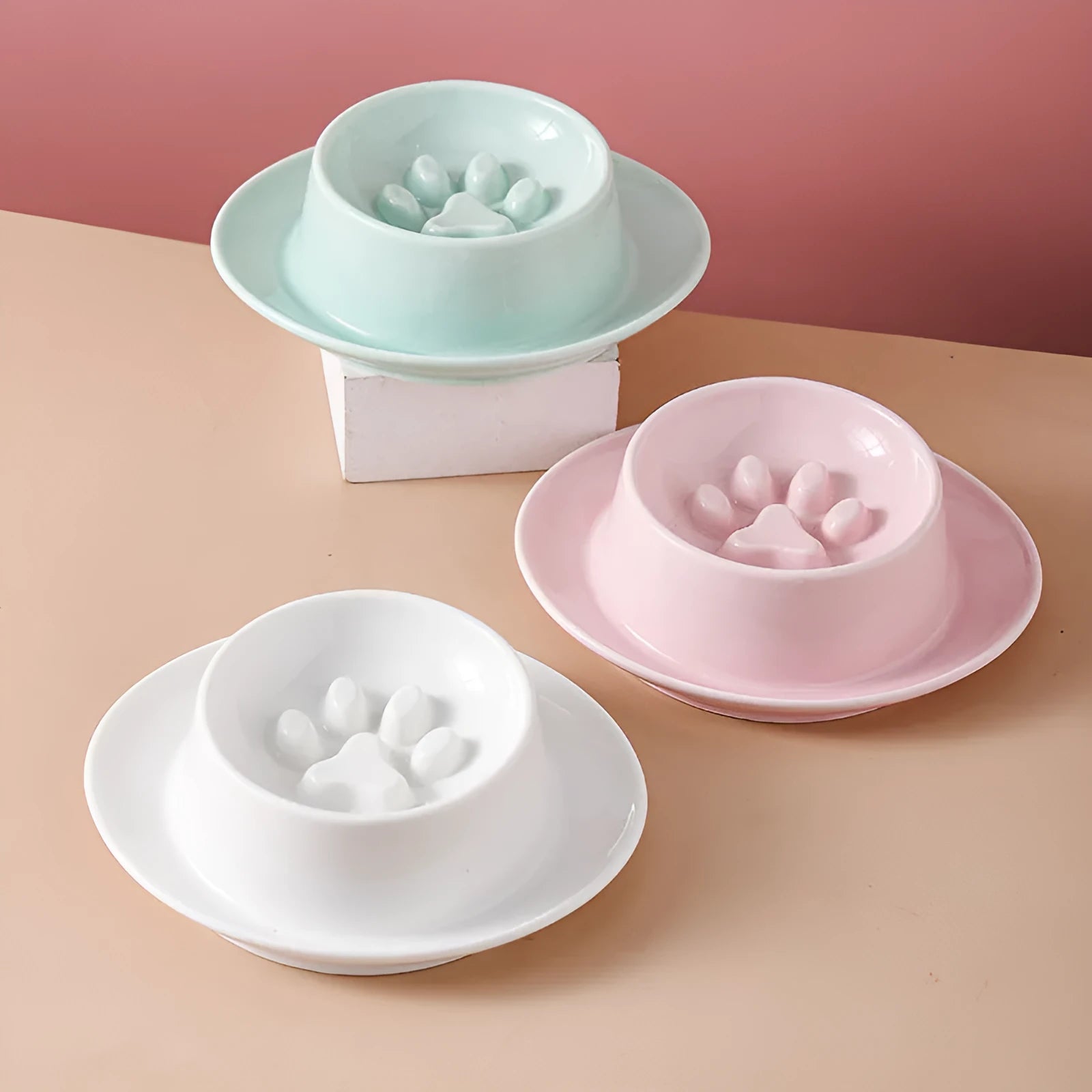 Green ceramic slow feed pet bowl with raised interior ridges and a non-slip black rubber base.