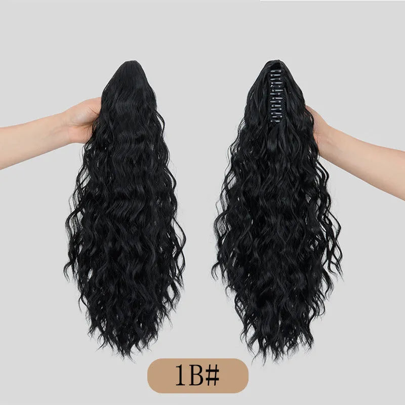 Synthetic corn curler wig with a textured water ripple grip ponytail, shown in a shade from the available colour range.