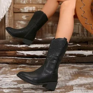 Women's black mid-calf Martin boots with a pointed chunky heel and hollow-out design on a white background.