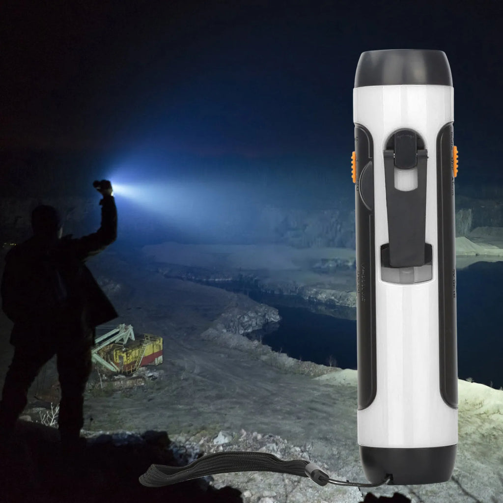 Orange emergency FM rechargeable alarm flashlight with hand crank on a dark outdoor background