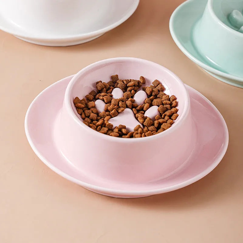 Green ceramic slow feed pet bowl with raised interior ridges and a non-slip black rubber base.