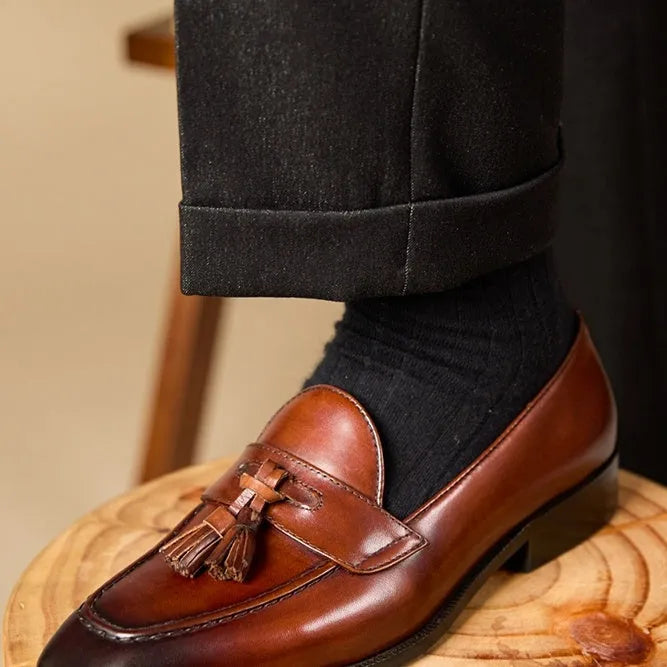 Men's polished leather tassel loafers in black and brown with pigskin lining and rubber sole