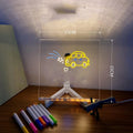 DIY acrylic LED message board on a desk with handwritten notes, glowing softly, next to colourful pens.