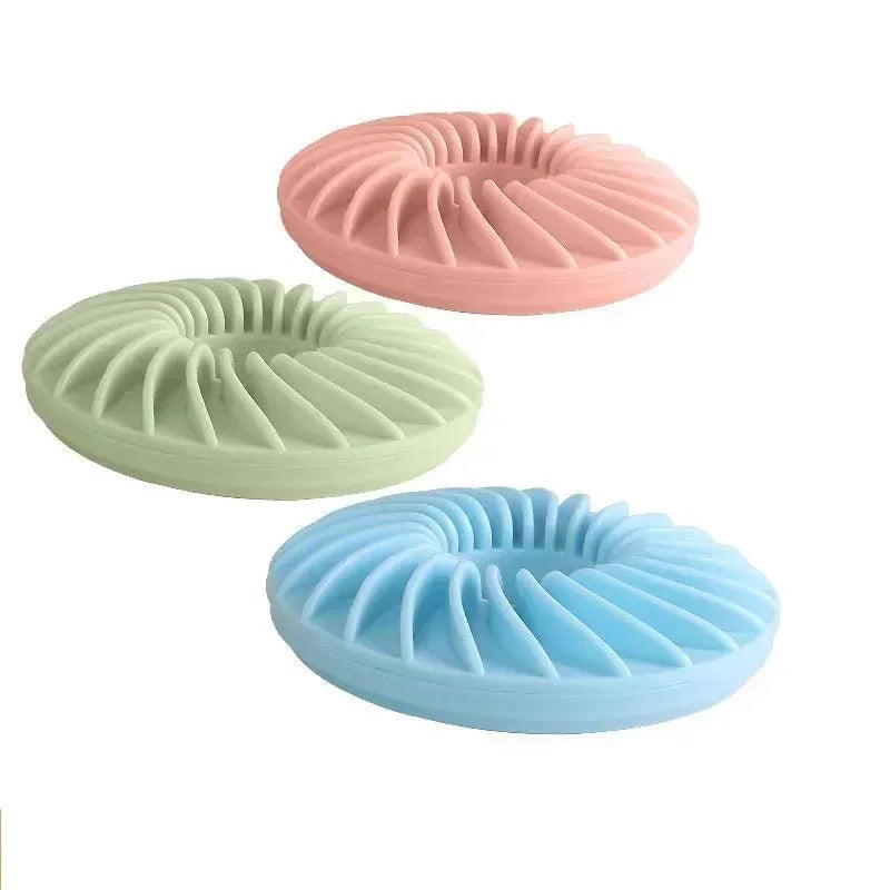 Soft round TPR leakage food pet toy for puppy slow feeding and teething in blue, green, and pink