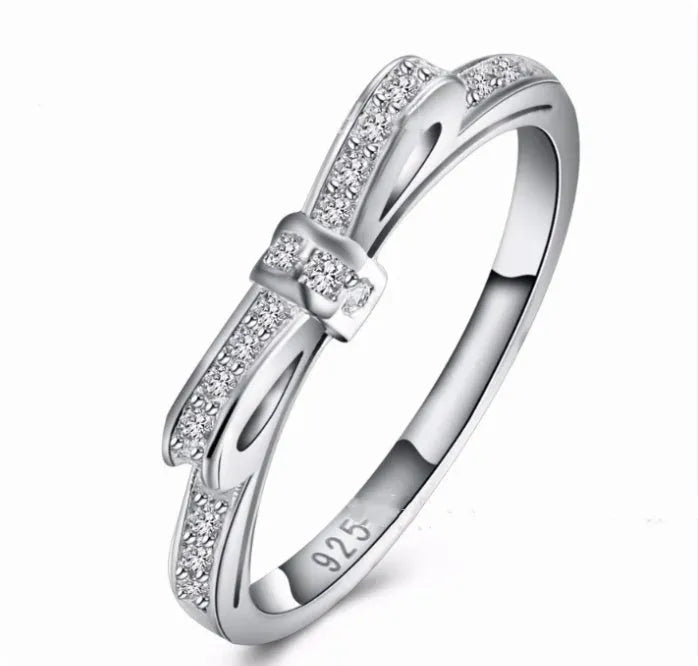 Silver plated fashion ring featuring a detailed 3D bow design set with sparkling zircon crystals on a plain band.