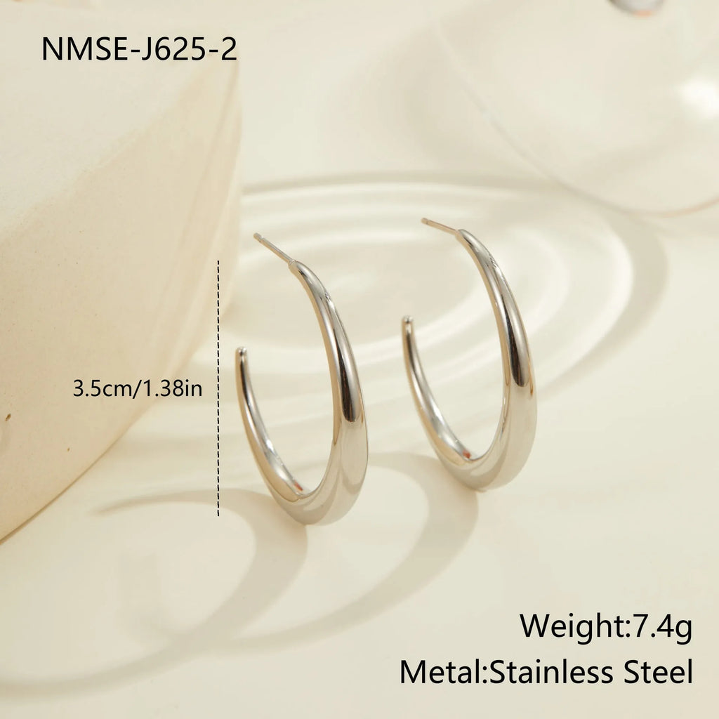 A pair of round titanium steel hoop earrings with an 18K gold plated finish, shown in large and small size options.