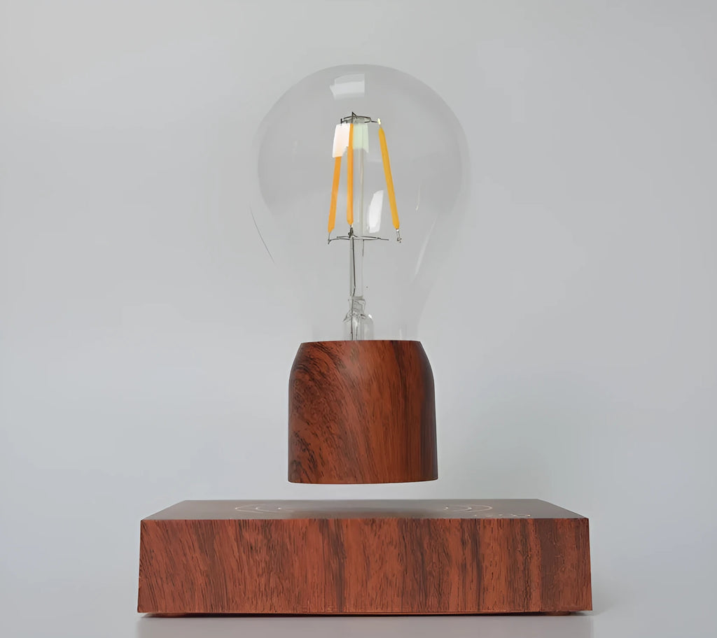 Magnetic levitation desk lamp with a floating glass bulb above an imitation wood base.