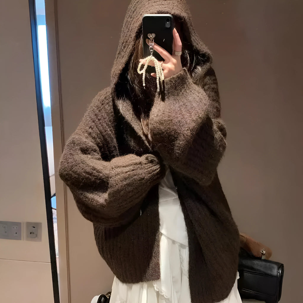 A woman's brown retro-style hooded cardigan with a loose fit, made from thick acrylic-polyester fabric.