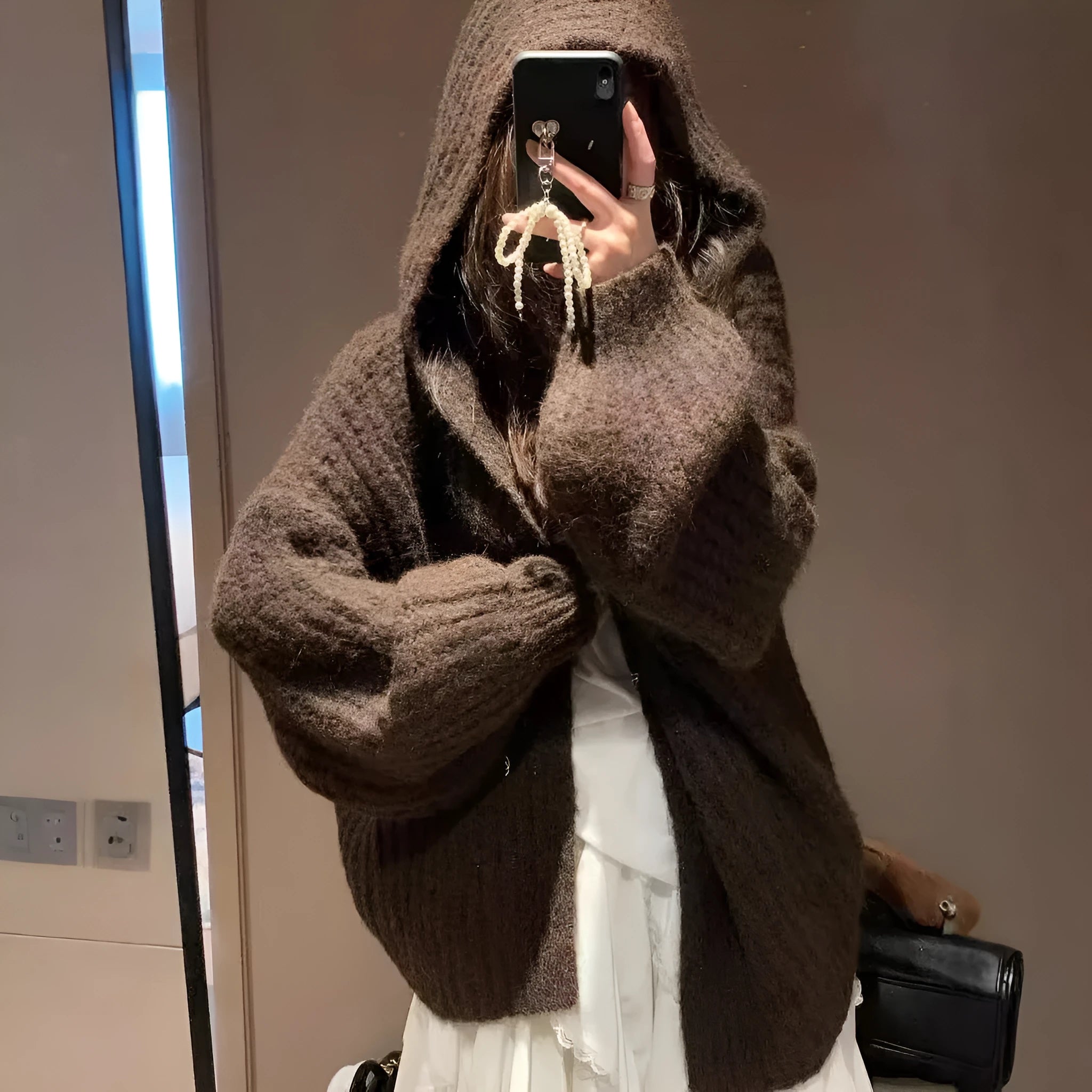 A woman's brown retro-style hooded cardigan with a loose fit, made from thick acrylic-polyester fabric.