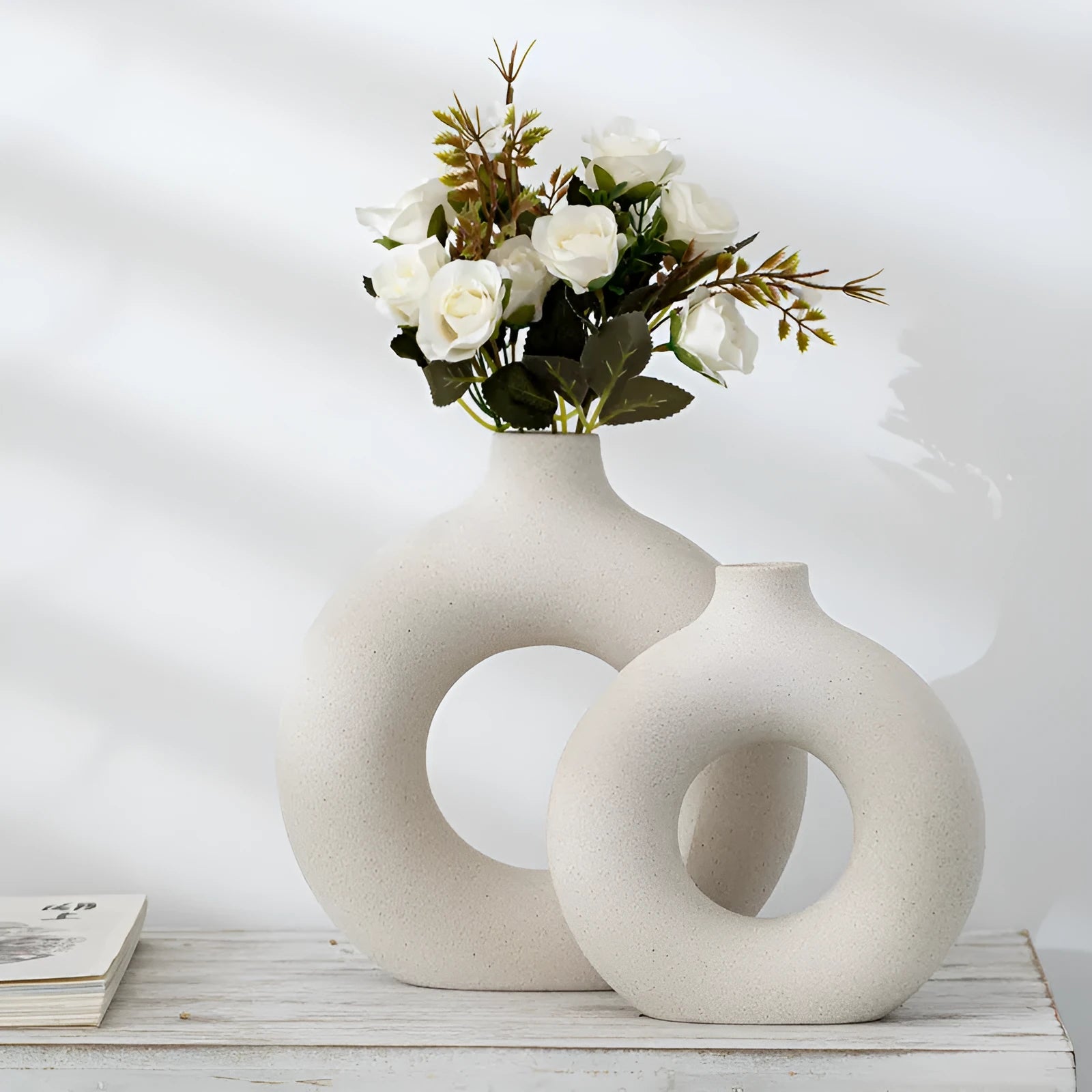 A simple modern frosted porcelain biscuit vase in a neutral colour, for flower arranging.