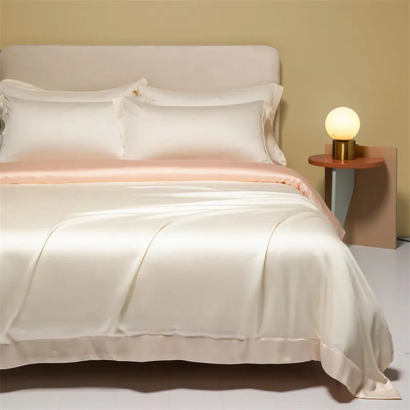 Luxury Tencel quilt cover and sheet set in Aurora Blue laid on a bed, showing deep pocket fitted sheet corner.