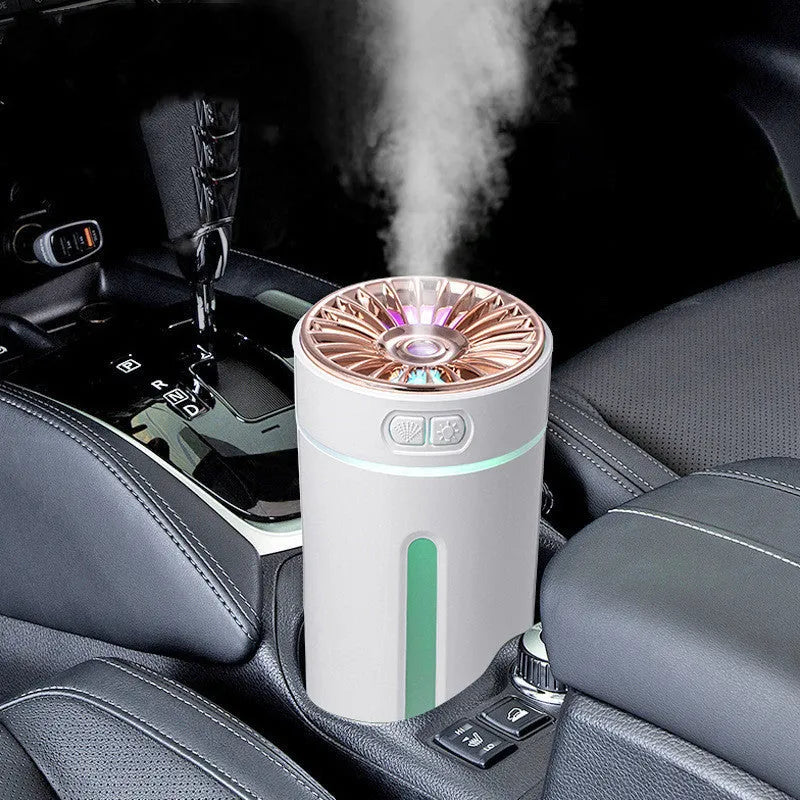 Black wireless USB car humidifier with colourful LED lights on a desktop next to a cup holder.