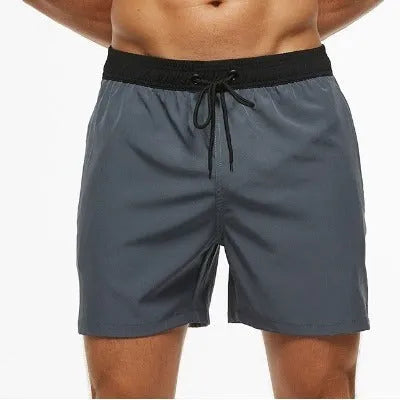 Men's blue athletic shorts with a drawstring waist and a visible zippered pocket on the hip.