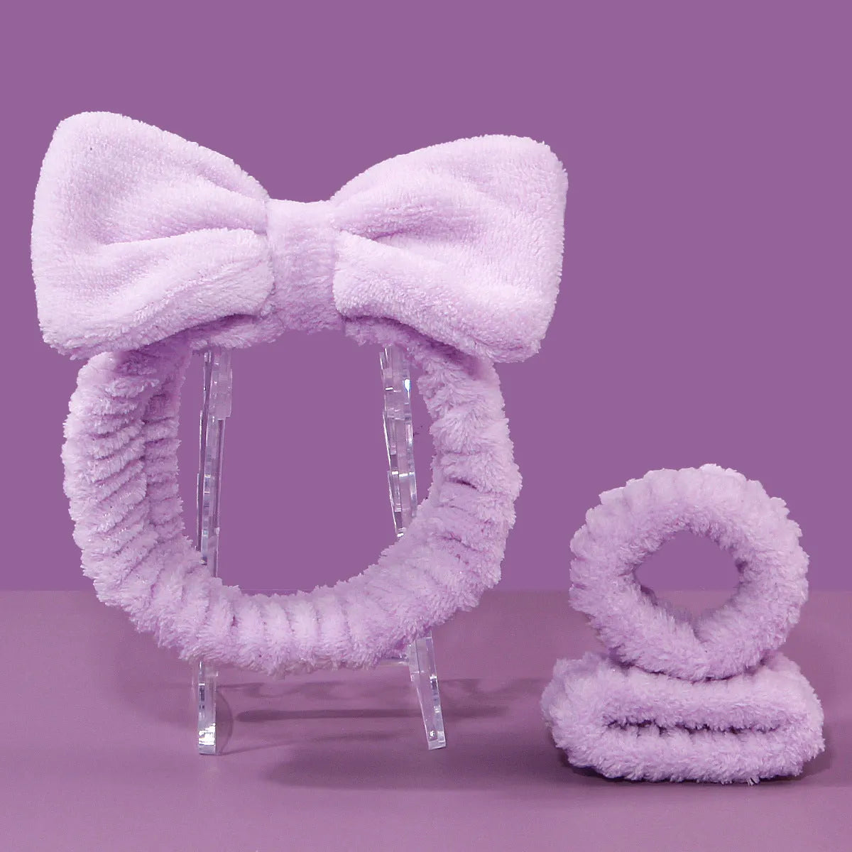 Three-piece facial skincare set showing a nylon brush and a coral fleece hair band in purple.
