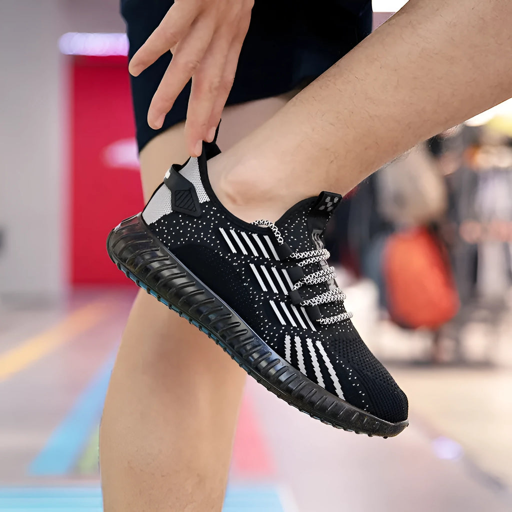 Men's white breathable flying fabric sports shoes with mesh lining and low upper design on a plain background.