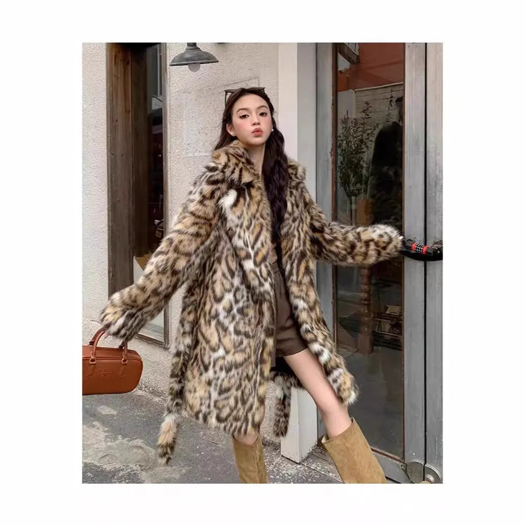 Long grey faux fur coat with a detachable fur collar and pockets on a model.