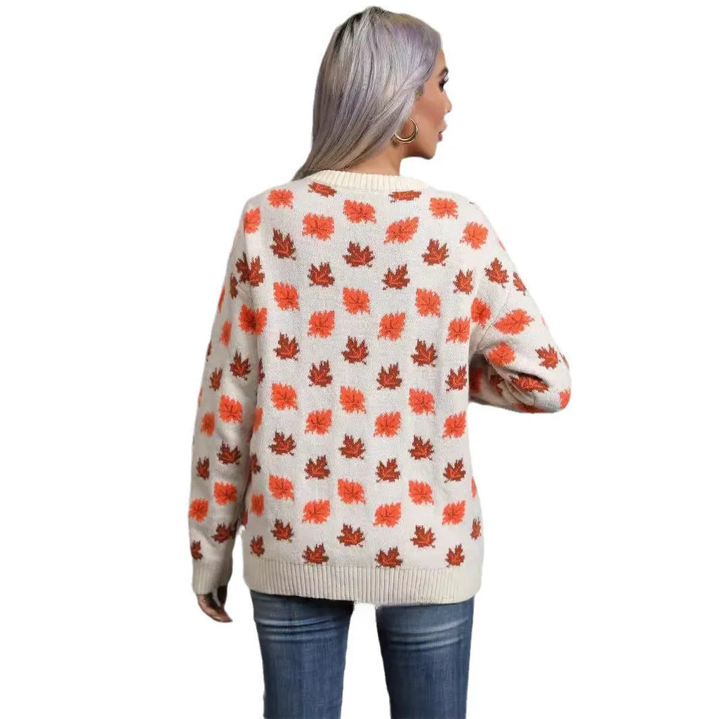 Beige loose fit Maple Leaf Christmas print pullover sweater with contrast details on a hanger.