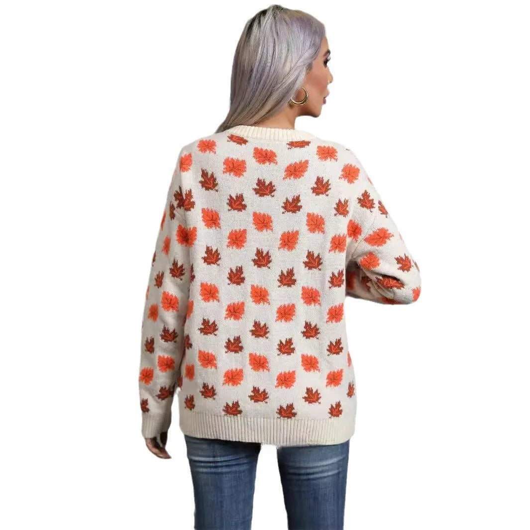 Beige loose fit Maple Leaf Christmas print pullover sweater with contrast details on a hanger.