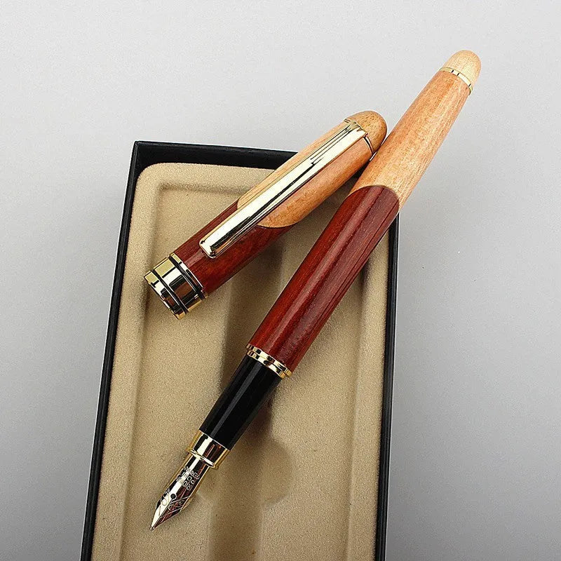 Wooden fountain pen with a metal clip next to a fabric pen bag on a desk.