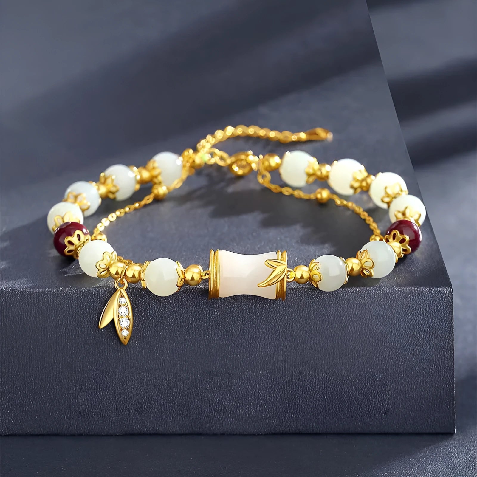 Bamboo-themed bracelet with a coloured glass flower and ruyi pattern in beige, green, light green, or white.