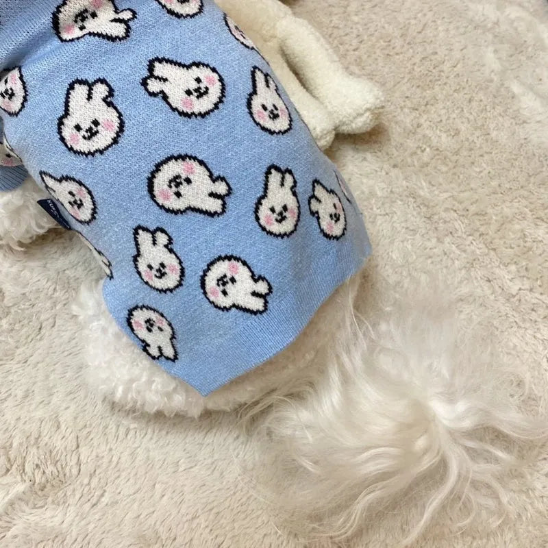 Small dog wearing a blue knitted winter sweater with a charming pattern, soft polyacrylic material
