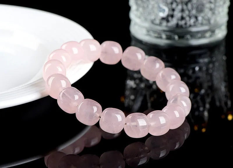 Pink crystal bamboo bracelet with 11x12mm geometric barrel beads on a wrist.