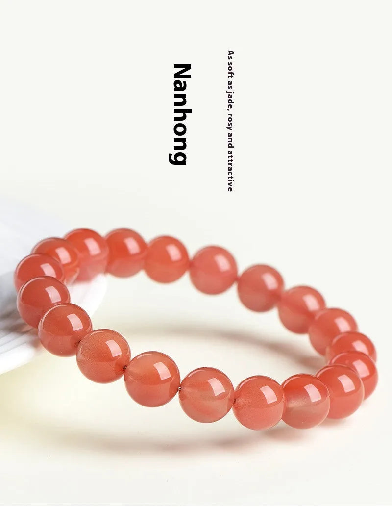 Natural cherry red agate beaded bracelet showing polished stones on a wrist, demonstrating single and triple strand options.