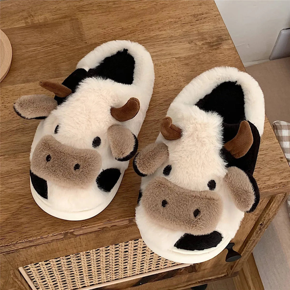 White cow plush slippers with cartoon milk cow pattern and non-slip textured sole
