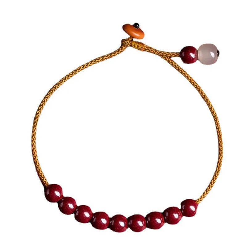 Hand-woven cinnabar bracelet with geometric design showing natural mineral colours