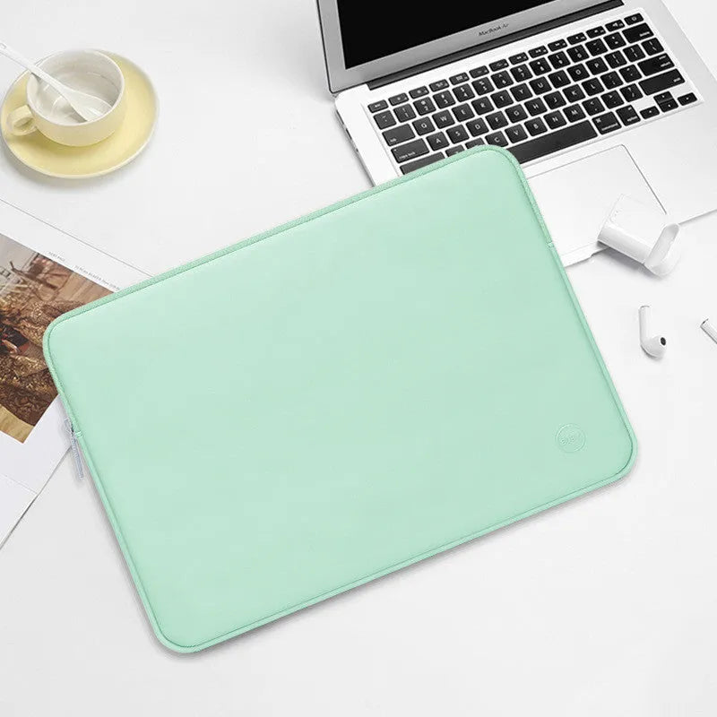 Laptop liner bag in mint green made from waterproof PU leather with shock-resistant padding, suitable for 13 to 17 inch laptops.