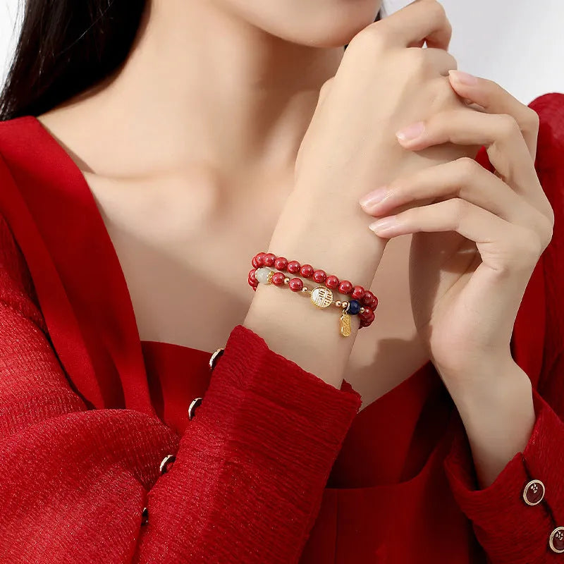 S925 sterling silver bracelet with Chinese blessing charms, cinnabar red and white shell accents on purple gold sandstone.
