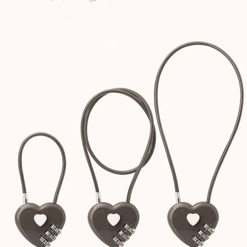 Peach heart-shaped wire rope padlock with a coiled steel cable, shown in various colours.