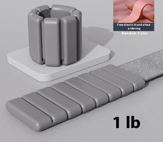 Silicone fitness wrist weight bracelet with Velcro strap in black, shown on a wrist.
