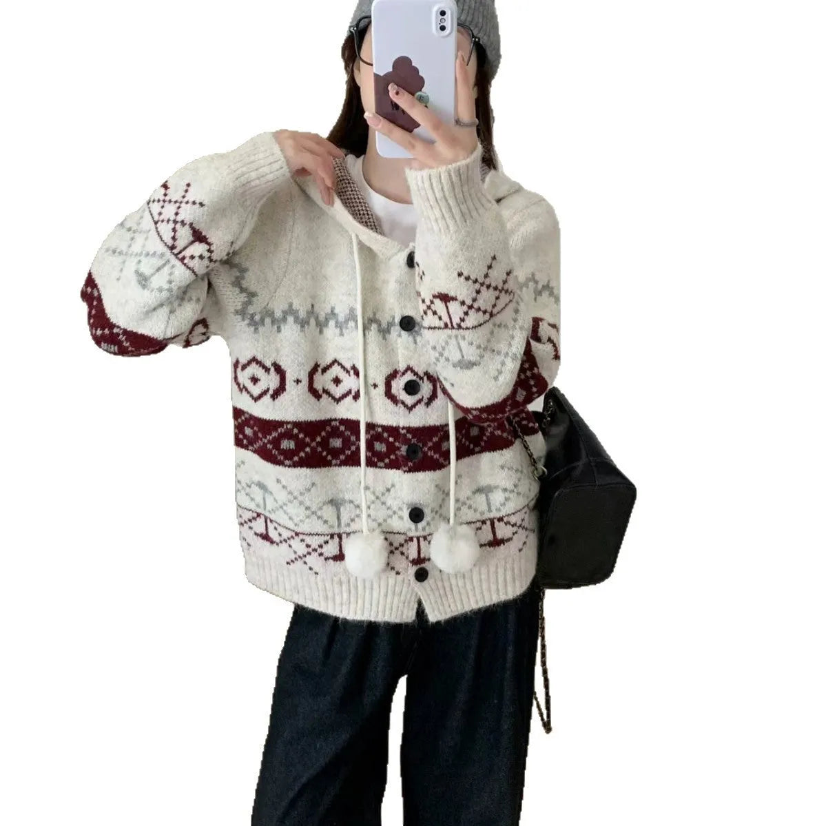 Woman wearing a beige loose-fit brocade sweater coat with a geometric pattern and long sleeves.