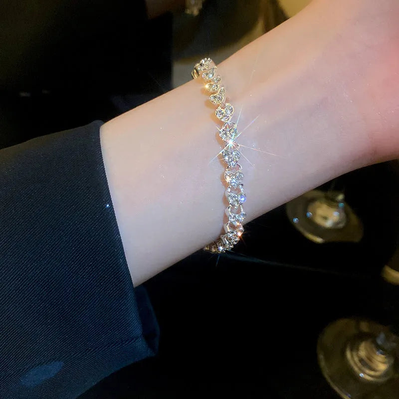 Silver metal bracelet with heart shape and inlaid zircon stones for women