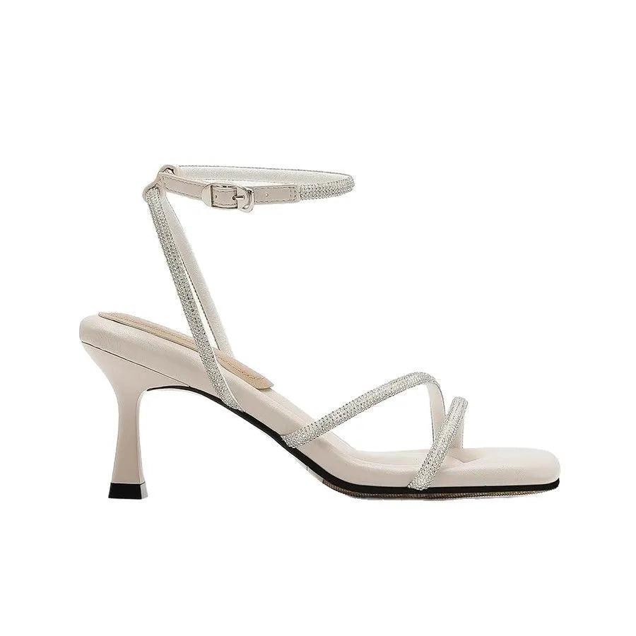 Women's silver rhinestone sandals with square toe and ankle strap buckle on a rubber sole.