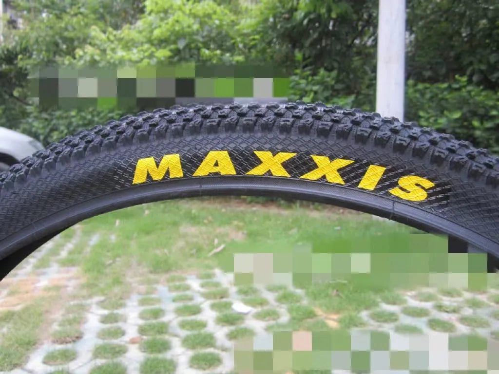Mountain bike tyre with tread, shown in multiple size options: 26, 27.5 and 29 inch diameters.
