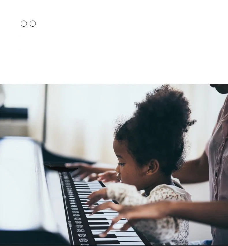 Pearl white portable electronic keyboard with rolled-out silicone keys and compact ABS plastic control panel.