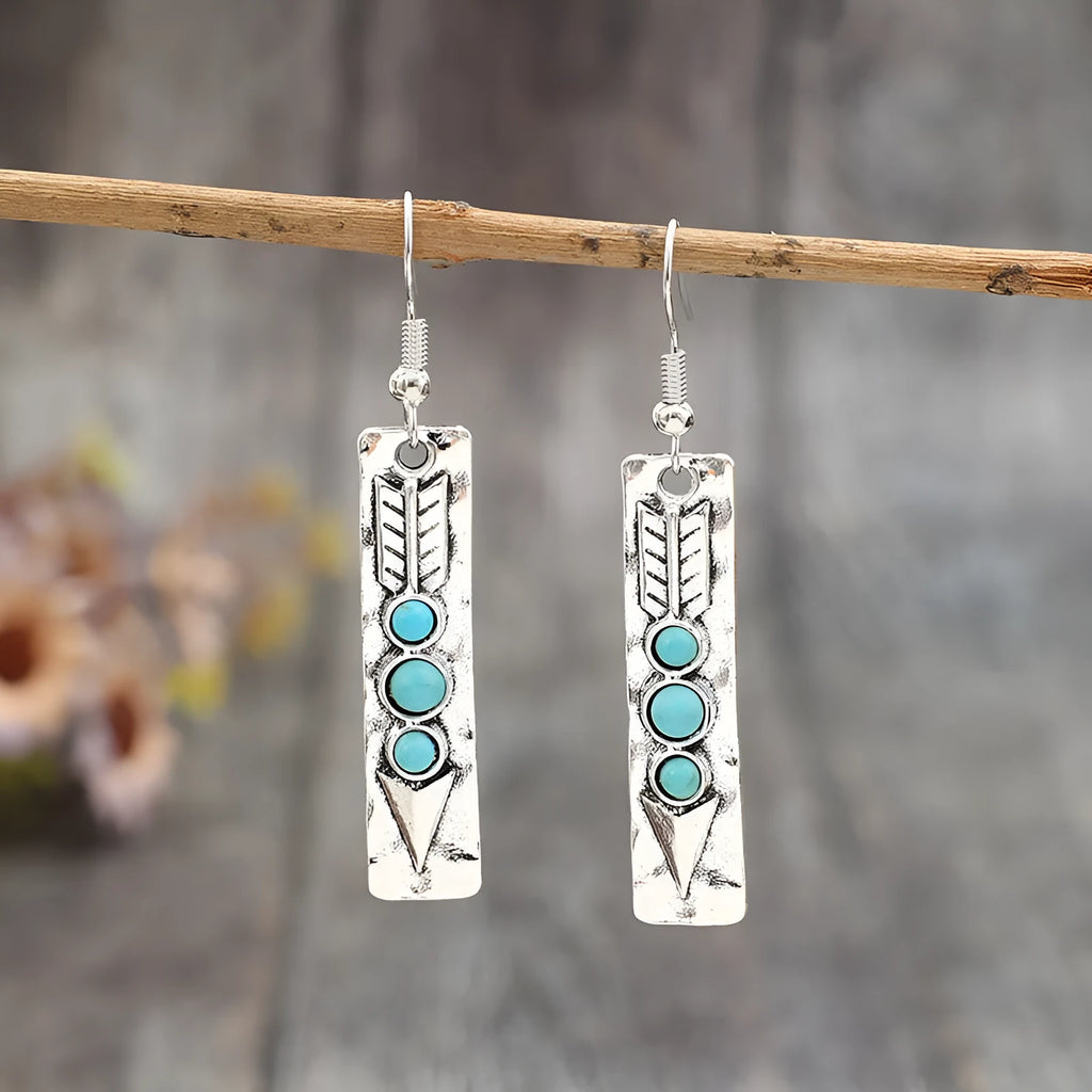 Silver long strip geometric earrings with turquoise inlay, showing front view.