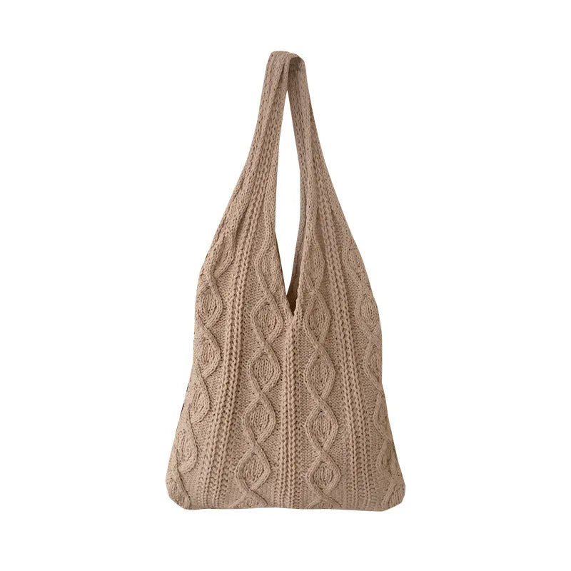 Light brown crochet knit tote bag with double shoulder straps on a wooden table.
