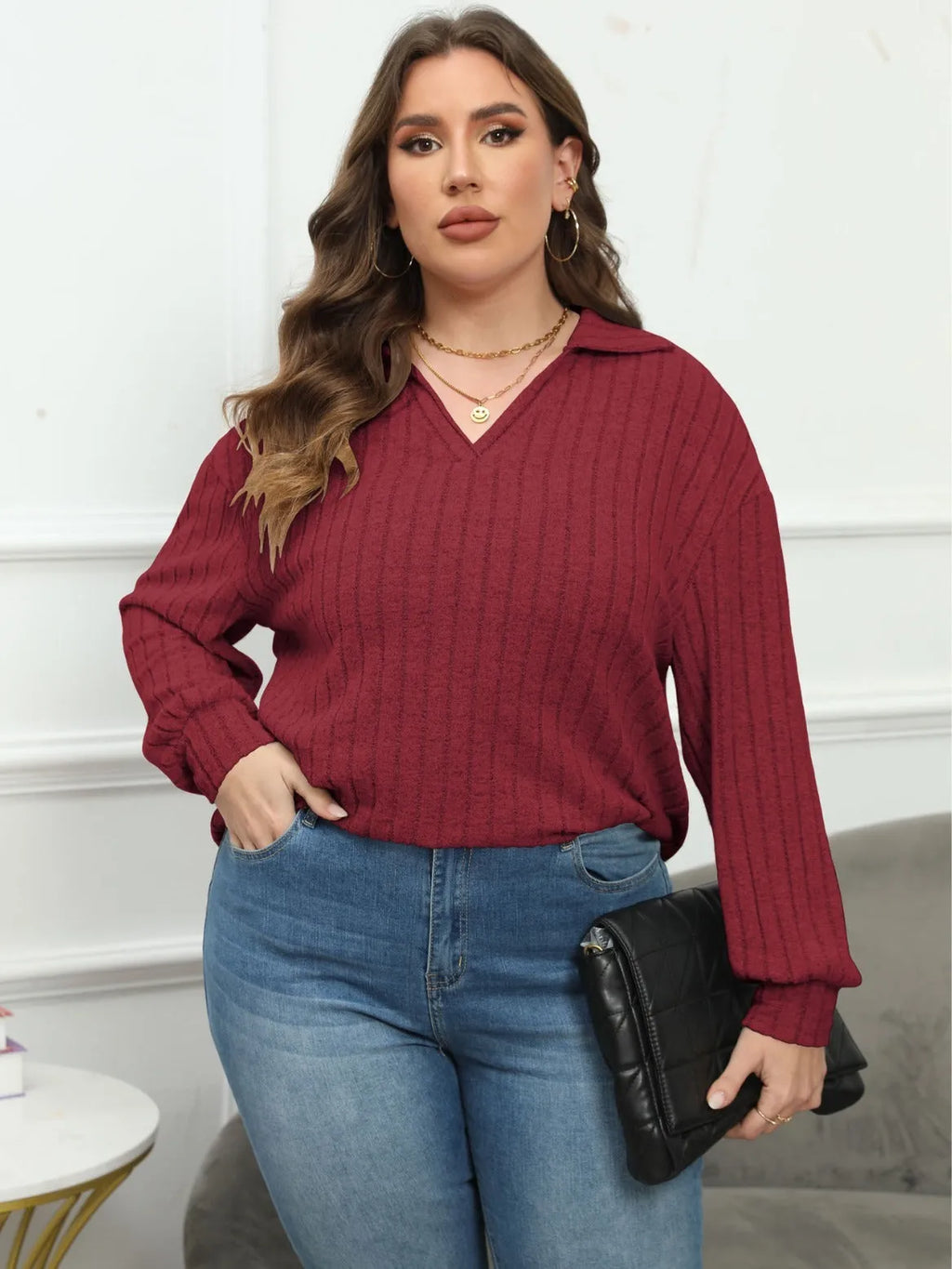 Women's plus size grey polo collar fleece shirt with lantern sleeves laid flat.