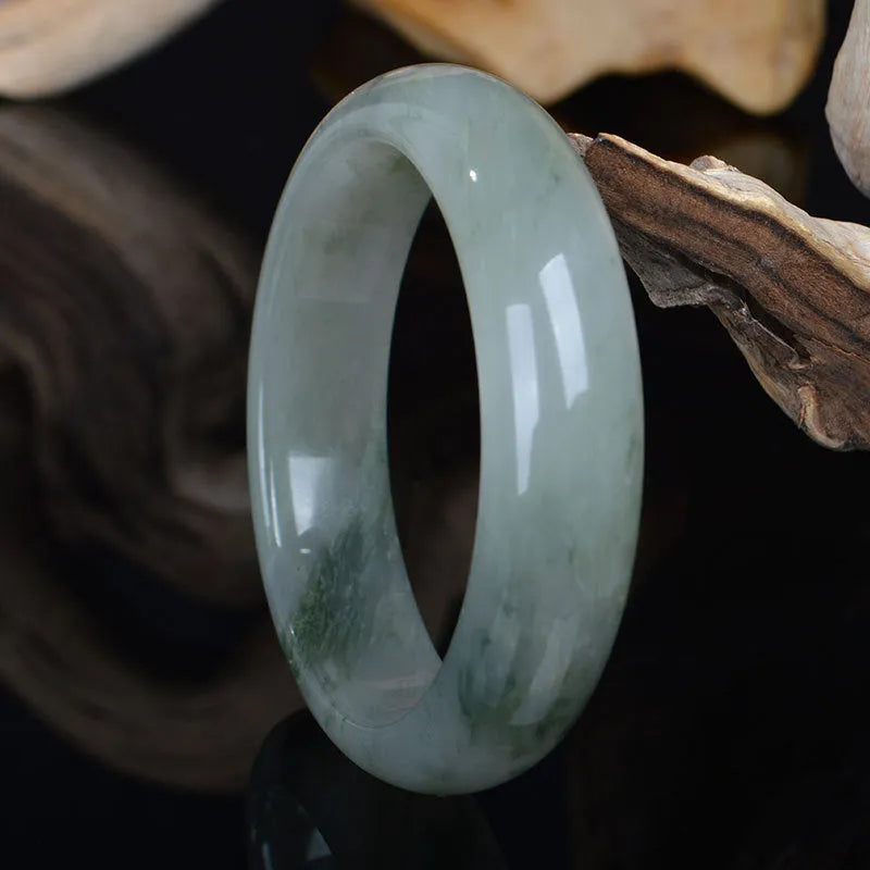 Natural Jinsi Jade Chinese style bangle bracelet on a plain background.