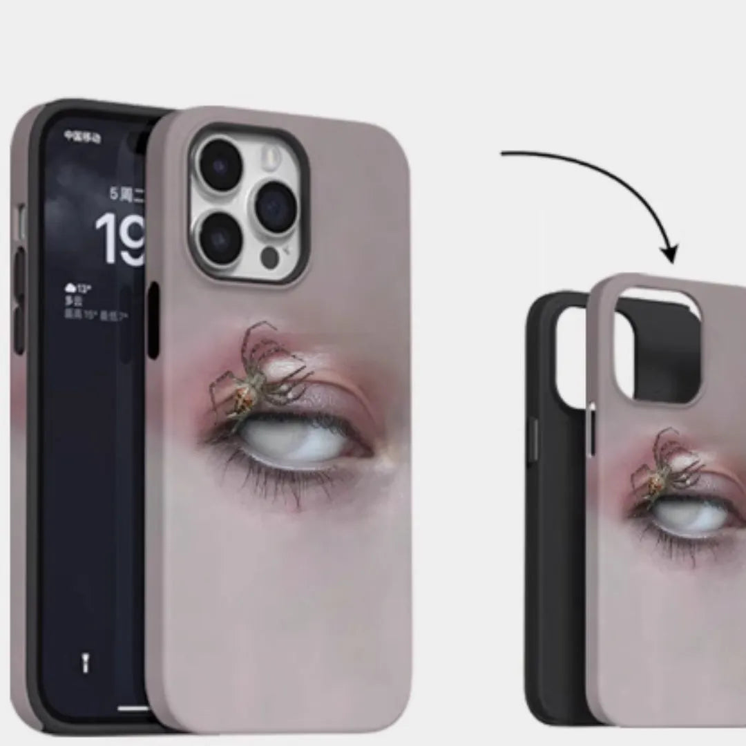 Dark frosted iPhone case with a spider web pattern, shown protecting a mobile phone.