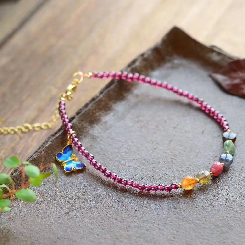 Purple garnet geometric anklet for women on an ankle.
