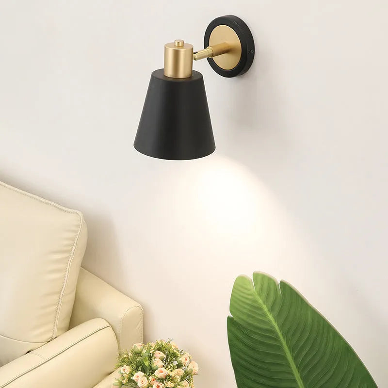 Nordic-style iron wall lamp mounted on a wall beside a bed.