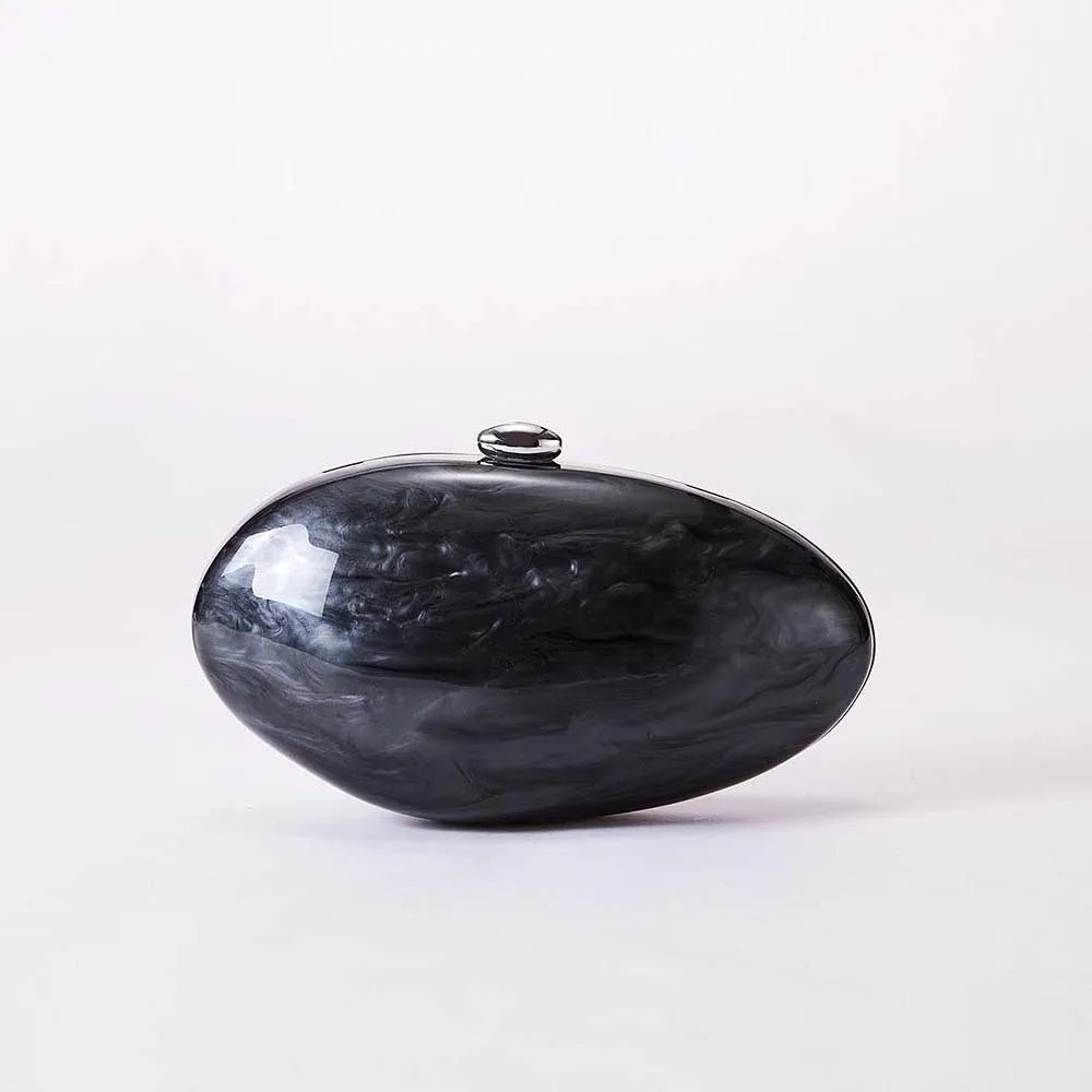 Acrylic oval crossbody bag shown in black with chain strap and hard shell