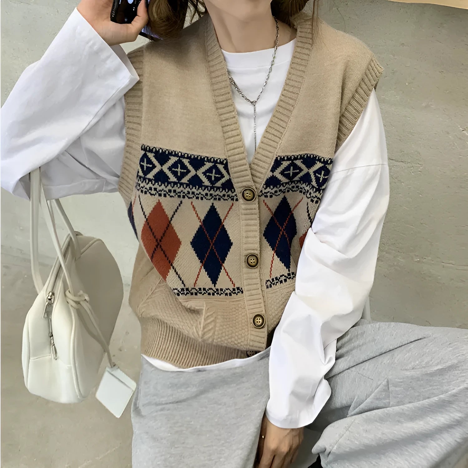 Loose sleeveless cardigan top in diamond plaid pattern, shown in khaki colour.
