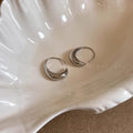 Teardrop hoop earrings in gold or silver tone alloy with C-shaped geometric design, one pair