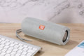 Fabric-covered portable Bluetooth speaker with a visible card slot in one of six colour options.