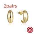 C-shaped sterling silver stud earrings with glossy electroplated finish in gold colour